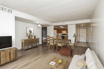 Pittsburgh apartment for rent - A living room with a white couch and wooden furniture.