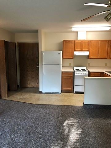 Edinboro apartment for rent - A kitchen with a white refrigerator and wooden cabinets.
