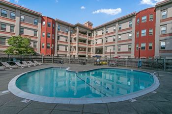 A swimming pool in front of an apartment building