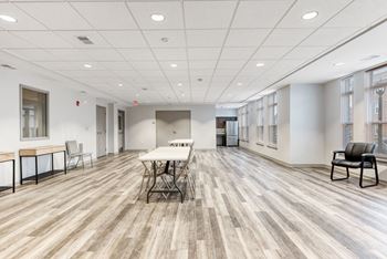 Resident community room with seating and kitchen