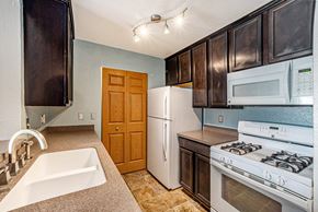 Monroe apartment for rent - a kitchen with a white refrigerator freezer next to a white stove top oven