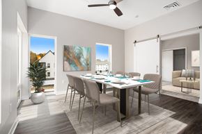 Hastings apartment for rent - A dining room with a table set for six and a potted plant on the floor.