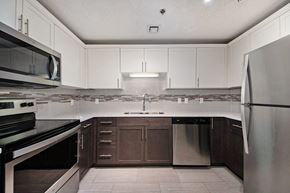 Grand Rapids apartment for rent - a kitchen with white cabinets and stainless steel appliances