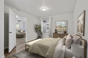 Spring apartment for rent - A bedroom with a bed, dresser, and painting on the wall.