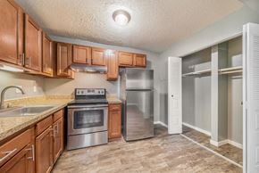 Portage apartment for rent - a kitchen with wooden cabinets and stainless steel appliances