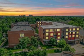 Madison apartment for rent - A sunset view of a campus with buildings and trees.