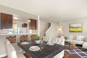Grand Rapids townhouse for rent - A modern dining room with a black table and white chairs.
