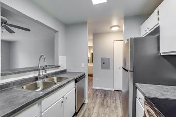 Madison apartment for rent - A modern kitchen with a stainless steel refrigerator and a double sink.