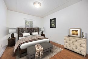 Grand Rapids apartment for rent - a bedroom with a bed and a dresser and a window