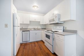 Grand Rapids apartment for rent - a kitchen with white appliances and white cabinets