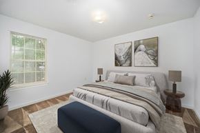 King apartment for rent - a bedroom with a bed and two paintings on the wall