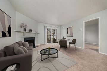 Portage apartment for rent - a living room with a couch and a table and a fireplace
