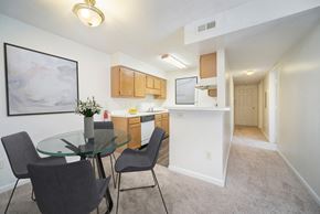 Greensboro apartment for rent - a dining room and kitchen with a glass table and chairs