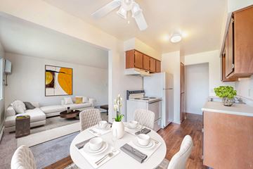 Battle Creek apartment for rent - a living room with a dining room table and a kitchen