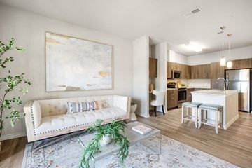 San Antonio apartment for rent - A living room with a white couch and a painting on the wall.