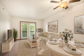 Kentwood apartment for rent - A dining room with a table set for two and a ceiling fan.