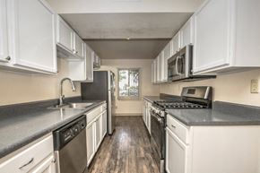 Sierra Vista apartment for rent - a kitchen with white cabinets and stainless steel appliances