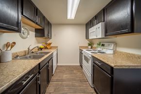 Flagstaff apartment for rent - A kitchen with black cabinets and a white microwave.