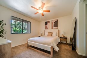 Flagstaff apartment for rent - A bedroom with a large bed and a ceiling fan.