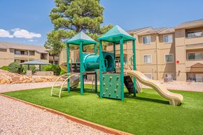 Flagstaff apartment for rent - A playground with a green slide and a blue roof.