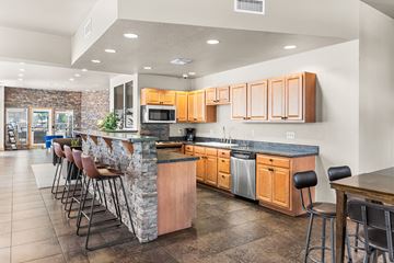 Flagstaff apartment for rent - A kitchen with a bar area and wooden cabinets.
