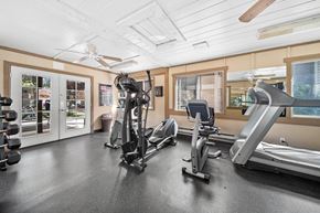 Flagstaff apartment for rent - A gym with a variety of equipment including treadmills, weights, and a fan.