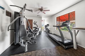 Cottonwood apartment for rent - A fitness center with a treadmill, elliptical trainer, and stationary bike.