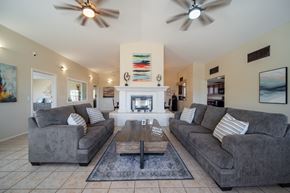 Oro Valley apartment for rent - A living room with a fireplace and two grey couches.
