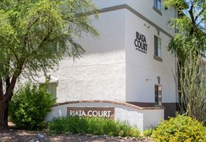 Tucson apartment for rent - A white building with the words "Riata Court" on it.