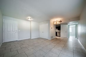 Tucson apartment for rent - A spacious room with tiled flooring and white walls.
