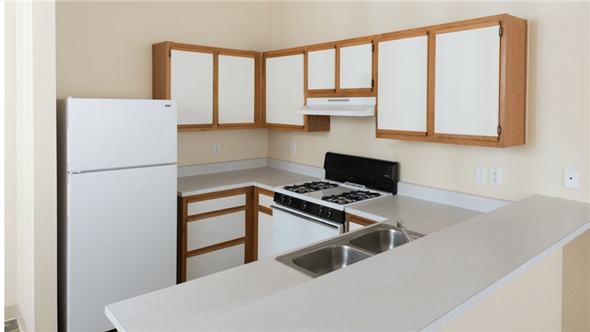 Cottonwood apartment for rent - A kitchen with a white refrigerator, stove, and sink.