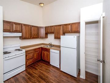 Cottonwood apartment for rent - a kitchen with white appliances and wooden cabinets