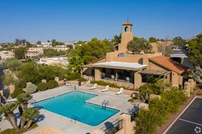 Tucson apartment for rent - View of the clubhouse with a pool and a tower.