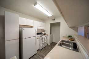 Tucson apartment for rent - A kitchen with white appliances and a white counter top.