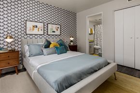 Tucson apartment for rent - A bedroom with a bed and two night stands.