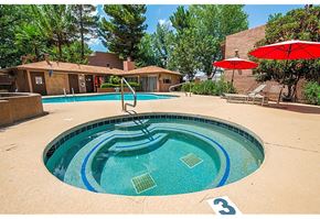 Sierra Vista apartment for rent - a pool with a slide and a hot tub in front of a building