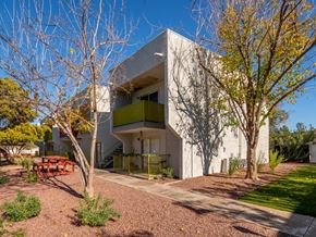 Tucson apartment for rent - a house with a white facade and a green balcony