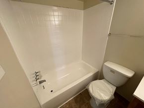 Washington apartment for rent - a bathroom with a bathtub and a toilet