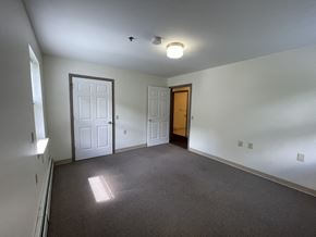 Guilderland apartment for rent - a bedroom with a carpeted floor and a door to a closet