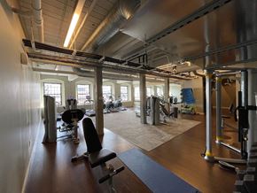 Hartford apartment for rent - a gym with fitness equipment and windows in a building