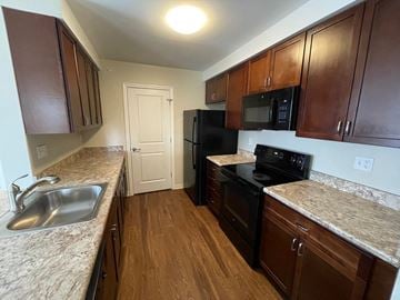 Suffield apartment for rent - a kitchen with black appliances and granite counter tops