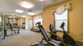 Walkersville apartment for rent - A well-equipped gym with treadmills, weights, and mirrors.