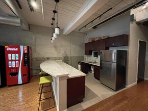 Hartford apartment for rent - a kitchen with a counter and a refrigerator and a soda machine