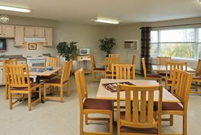 Troy apartment for rent - a dining room with tables and chairs and a kitchen