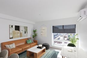 West Hartford apartment for rent - A living room with a brown couch, a white chair, and a coffee table.