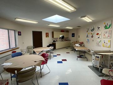 Bloomfield apartment for rent - a classroom with tables and chairs and a kitchen