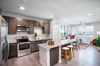 A modern kitchen with a large island and stainless steel appliances