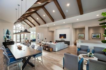 A living room with a dining room table and a couch