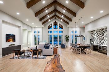 A modern living room with a large wooden floor and a high ceiling