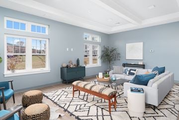 East Greenwich apartment for rent - A living room with a white couch, a wooden coffee table, and a rug with a geometric pattern.